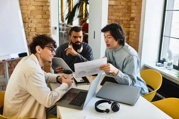 Three professionals collaborate, exchanging ideas and reviewing documents in a lively office. — Stock Photo