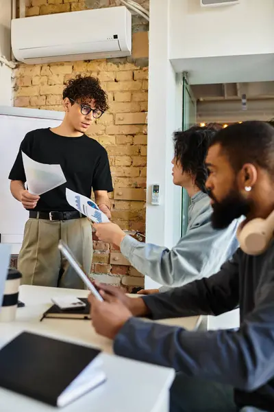 A team of professionals discusses and shares insights and documents while brainstorming. — Stock Photo