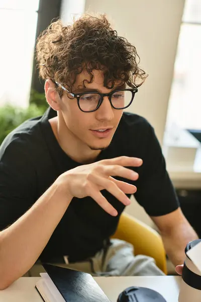 A thoughtful young man shares ideas while collaborating in an inviting office environment. — Stock Photo