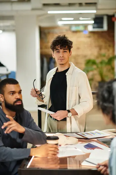 Colleagues actively share ideas while working on a project in a vibrant office environment. — Stock Photo