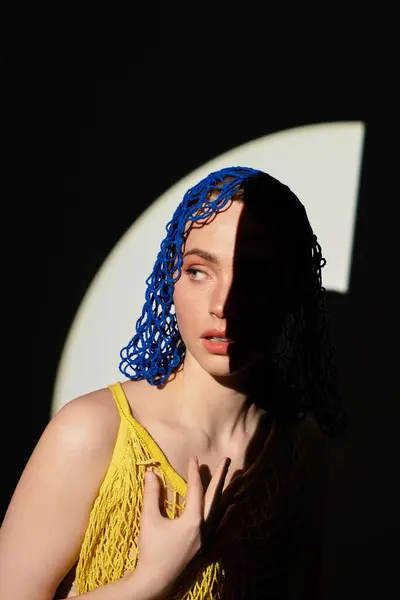 Young woman shows off her unique hairstyle in captivating dynamic lighting and shadows. — Stock Photo