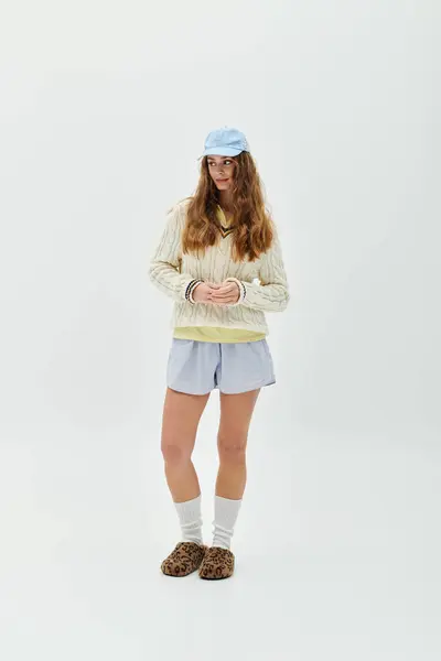 Confident young woman poses in a stylish outfit with a calm expression on a white background. — Stock Photo