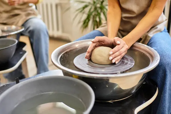 A young couple shapes clay and shares laughter in a cozy pottery studio. — Stock Photo