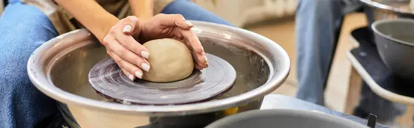 A young couple shapes clay together at a pottery studio, enjoying their creative bond. — Stock Photo
