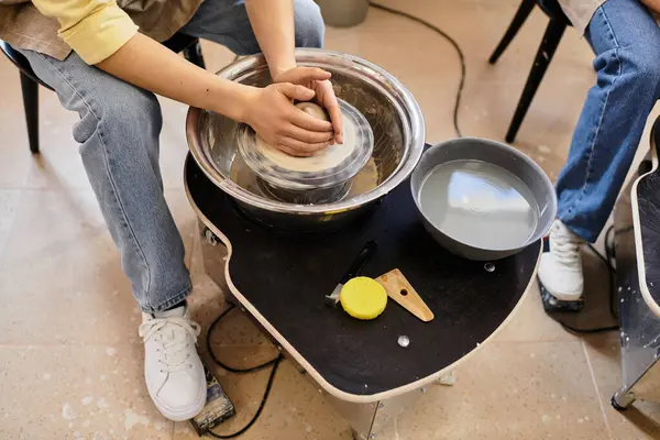 Young couple shares laughter and love while crafting pottery in an inspiring studio. — Stock Photo