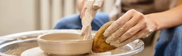 Artistic creation unfolds as skilled hands shape clay into beautiful pottery in a lively studio — Stock Photo