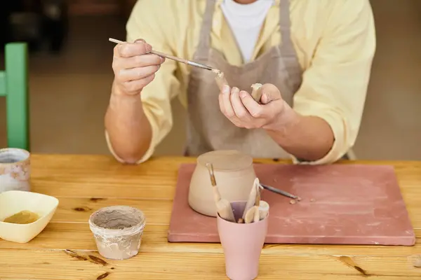 Artisan engages in pottery creation, skillfully molding clay in an inviting workspace. — Stock Photo