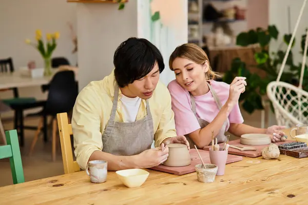 Young couple explores their creativity while making pottery at a charming art studio — Stock Photo