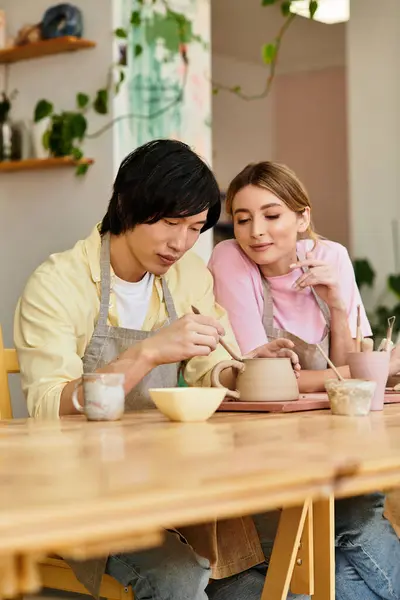Couple joyfully collaborates on a pottery project in a cozy art studio filled with inspiration. — Stock Photo