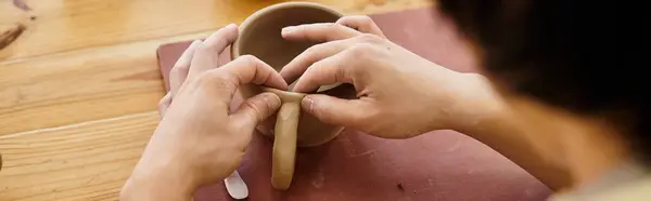 Hands skillfully shape a mug in a bright pottery studio, surrounded by tools and creativity. — Stock Photo
