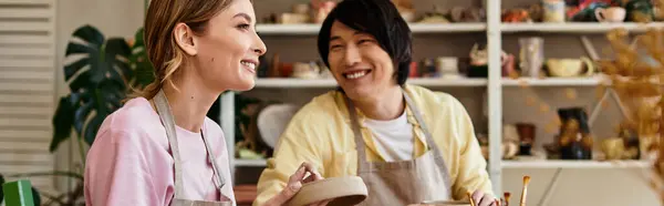 A couple crafts unique pottery together, sharing smiles and laughter in their studio. — Stock Photo