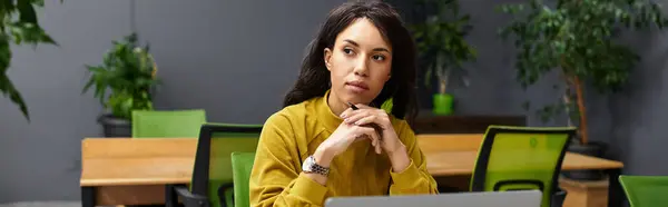 Elegant young woman thoughtfully focused on her tasks while working in a contemporary office space — Stock Photo
