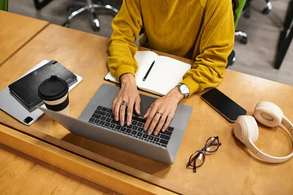 Beautiful young professional focuses on her laptop in a contemporary office environment. — Stock Photo