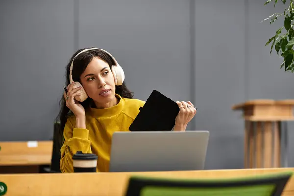 Focused young professional utilizing technology and enjoying a productive atmosphere in an office. — Stock Photo