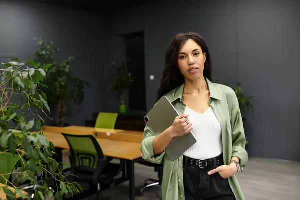 Young professional woman engages in office tasks, seeking inspiration amid chic decor and plants. — Stock Photo