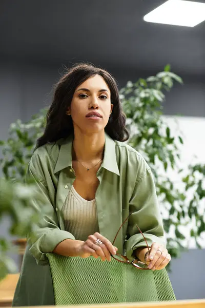 A young woman works hard in a stylish, plant filled office with plenty of natural light. — Stock Photo