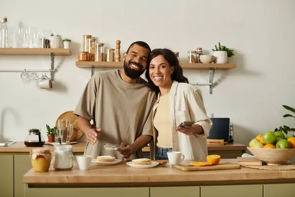 A joyful african american couple shares laughter and delicious breakfast in their charming kitchen. — Stock Photo