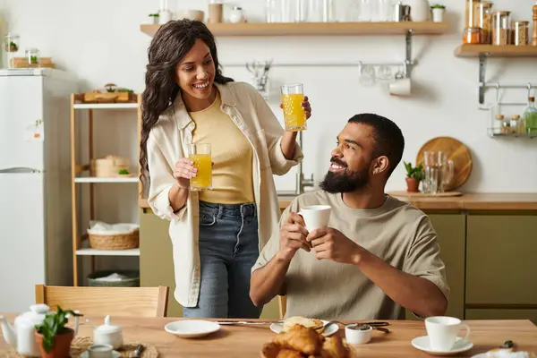 Un'atmosfera calda a casa circonda una coppia amorevole godendo di una colazione gioiosa insieme. — Foto stock