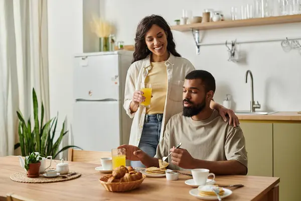 A happy couple enjoys a relaxing breakfast together, filled with love and warmth in their home. — Stock Photo
