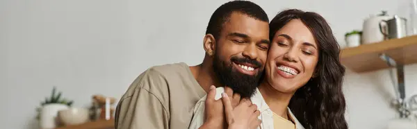 In a cozy space, an affectionate couple embraces, radiating love and connection while at home. — Stock Photo