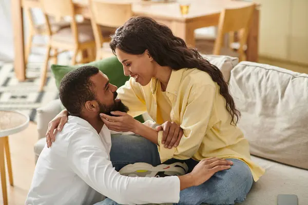 A loving African American couple shares a cozy, joyful moment at home, embracing warmly. — Stock Photo