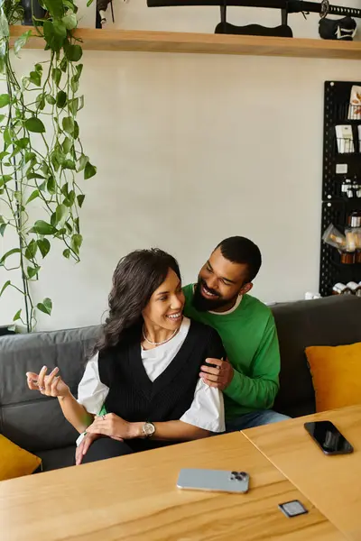 A charming couple shares laughter and warmth while enjoying their time at a cozy cafe. — Stock Photo