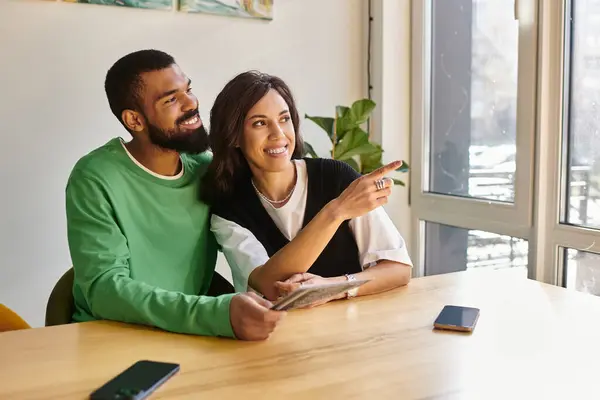 An african american couple enjoys each other's company while smiling and sharing stories in a cafe. — Stock Photo