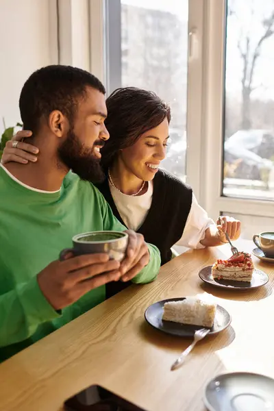 A couple enjoys sweet moments with cake and tea in a cozy caf, cherishing each other — Stock Photo