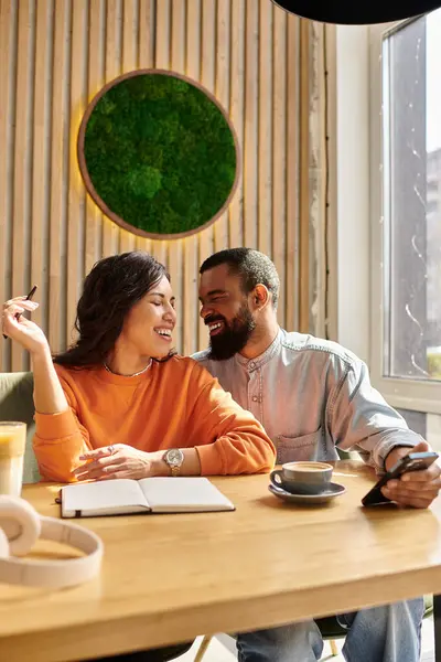 An African American couple shares a joyful moment in a cozy cafe, enjoying each other's company. — Stock Photo