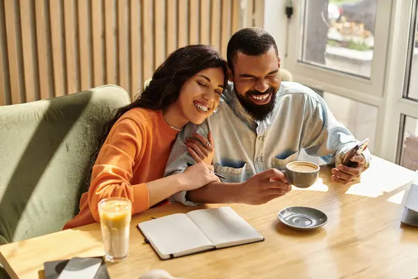 An african american couple shares joyful moments over coffee at a cafe, enhancing their bond. — Stock Photo