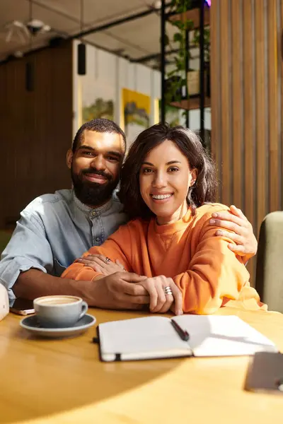 An engaged couple enjoys each others company while sipping coffee in a vibrant cafe — Stock Photo