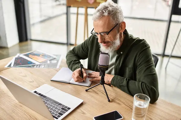 A focused professional engages in brainstorming while taking notes at a stylish work desk. — Stock Photo