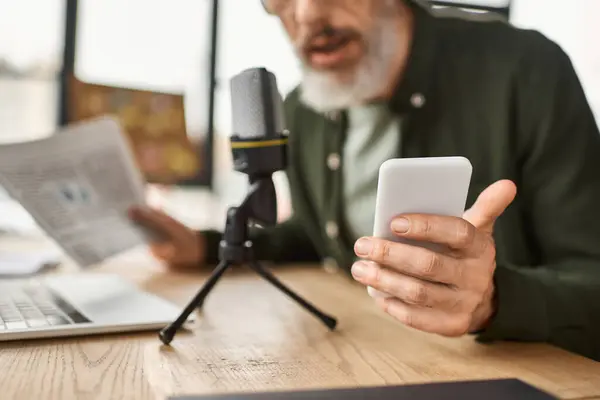 A person uses a smartphone to record audio in a stylish workspace with documents. — Stock Photo