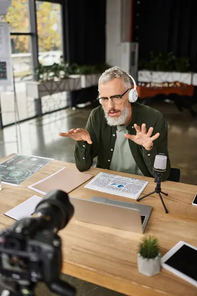 A focused professional conducts an engaging online discussion in a contemporary office setting. — Stock Photo