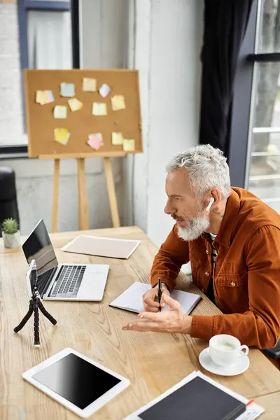 A person joins a virtual discussion in a tidy workspace with notes in view. — Stock Photo