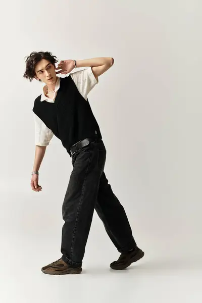 A handsome young man poses in a stylish outfit, exuding confidence and charm indoors. — Stock Photo