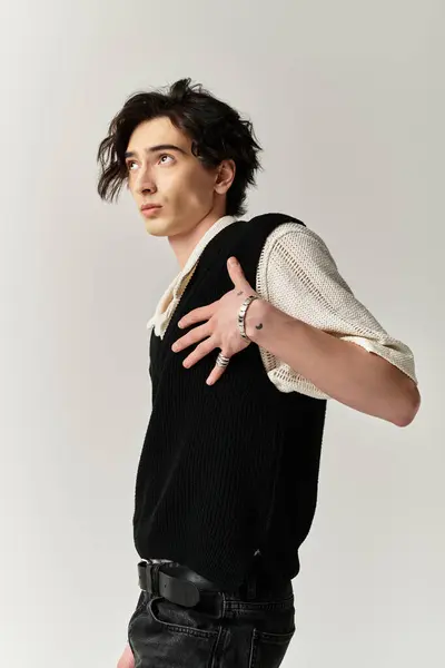 A handsome young man poses confidently in a trendy outfit, exuding charm and style. — Stock Photo