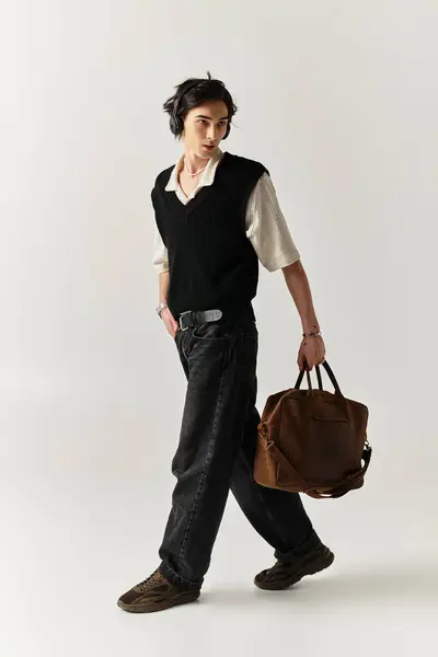 Handsome young man walks confidently in a stylish outfit within a contemporary studio space. — Stock Photo
