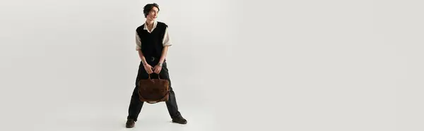 A handsome young man confidently poses in a trendy outfit, highlighting contemporary fashion style, banner — Stock Photo