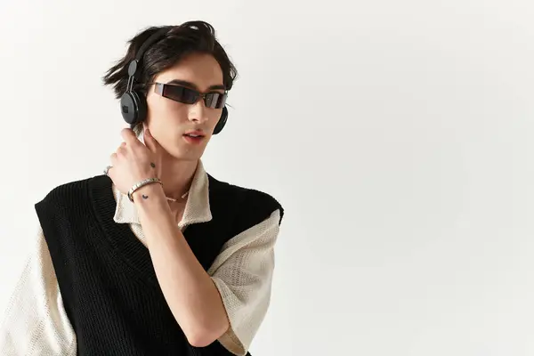 Handsome young man displays modern outfit in studio, exuding confidence and creativity. — Stock Photo