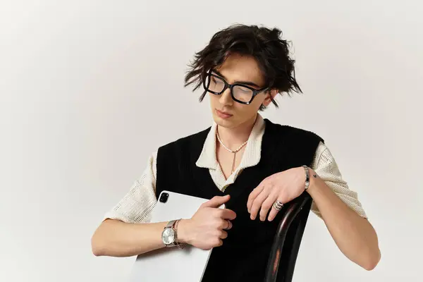 Young man showcases a chic outfit and trendy accessories while posing in a bright studio. — Stock Photo