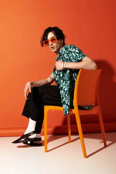 Standing casually with confidence, a young man exudes trendy summer vibes in a studio setting. — Stock Photo