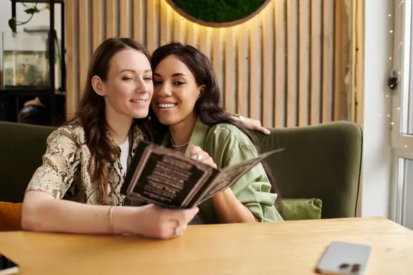 Inside a warm cafe, a joyful couple enjoys each others company as they browse the menu. — Stock Photo