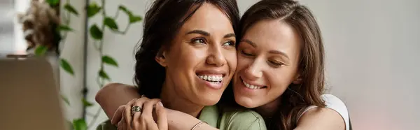 Two women embrace warmly while enjoying a delightful moment together at a cafe. — Stock Photo