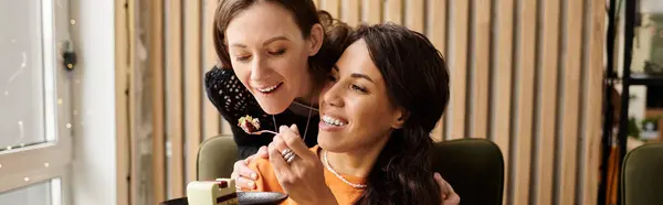 Two women share a special moment at a charming cafe, enjoying each others company and dessert. — Stock Photo