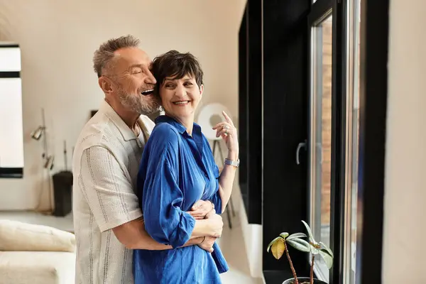 A cheerful couple embraces each other, enjoying quality time together at home. — Stock Photo