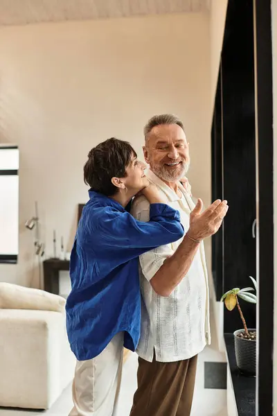 A couple embraces with warmth and laughter while enjoying their time together at home. — Stock Photo