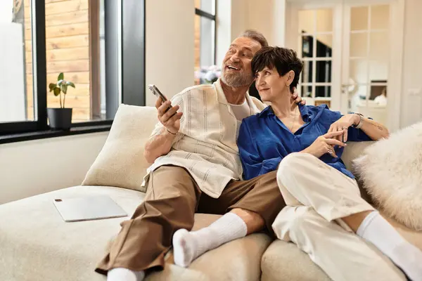 A middle aged couple enjoys a delightful moment together at home, laughing and sharing joy. — Stock Photo