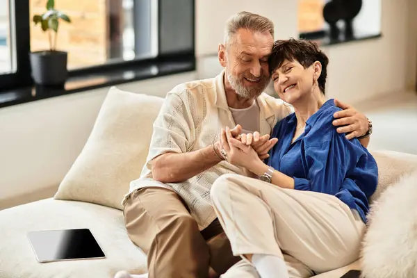 Middle aged couple enjoys tender moments together in their warm and inviting home space. — Stock Photo