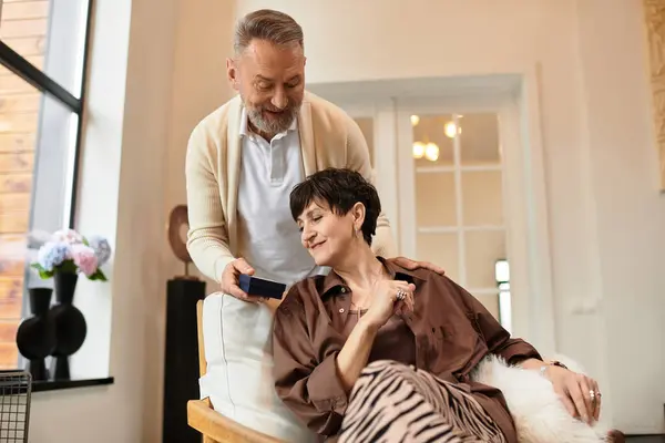 A couple enjoys a lovely interaction at home, sharing laughter and warmth with each other. — Stock Photo